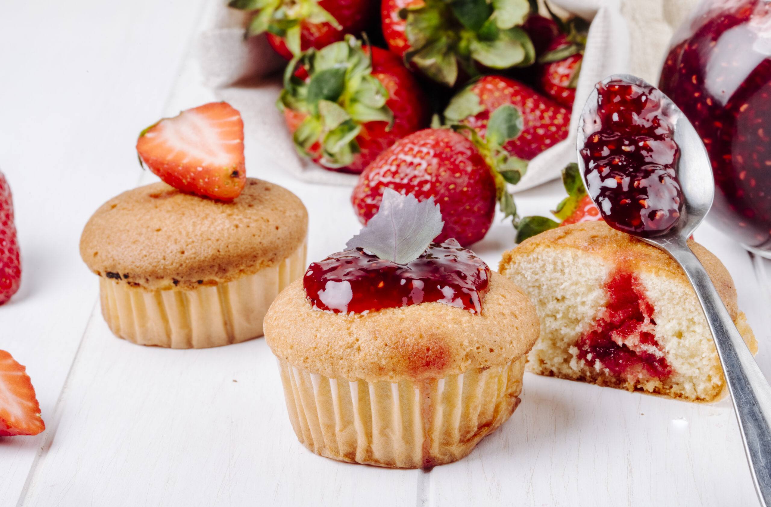 side view cupcakes with strawberry jam basil fresh strawberry white background scaled